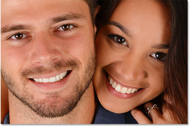 The man's teeth have been whitened in Photoshop. The woman's teeth are still yellow