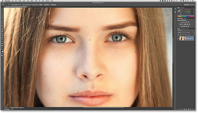 Zooming in on the woman's eyes with the Zoom Tool. Image © 2016 Photoshop Essentials.com