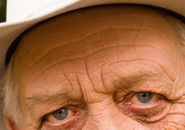 A close-up of the man's forehead showing the original wrinkles. Image © 2016 Photoshop Essentials.com