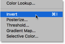 Choosing the Invert comand from under the Image menu. Image © 2016 Steve Patterson, Photoshop Essentials.com