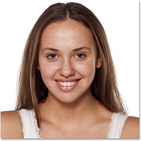 Smiling young woman without make-up, looking at the camera. Image #89969729 licensed from Adobe Stock by Photoshop Essentials.com