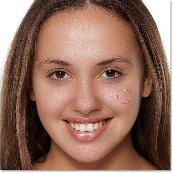 Painting with white on the layer mask to reveal the skin softening effect on her nose, cheeks, and around her eyes. Image © 2016 Steve Patterson, Photoshop Essentials.com