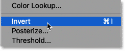 Selecting the Invert command in Photoshop. 