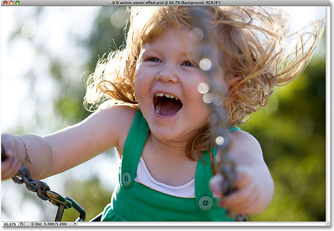 A photo of a young girl on a swing. Image licensed from iStockphoto by Photoshop Essentials.com.