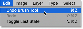 Choosing the Undo Brush Tool command from the Edit menu in Photoshop