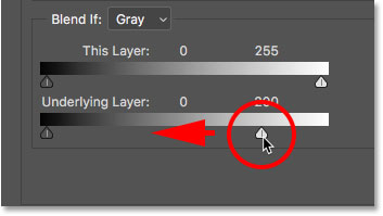 Dragging the white Underlying Layer slider to the left in the Layer Style dialog box