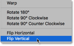 Selecting the Flip Vertical command from under the Edit menu in Photoshop. 