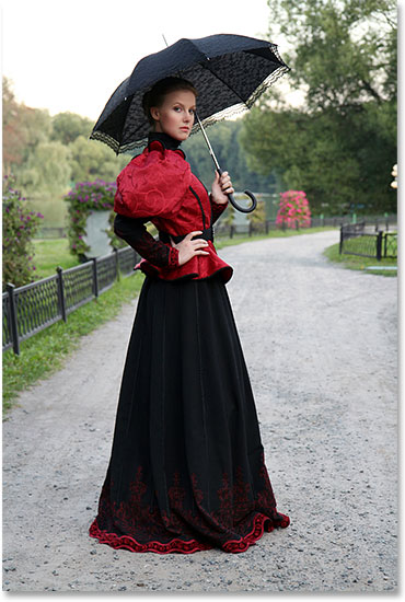 Girl with an umbrella in a vintage suit in a park. Image licensed from Shutterstock