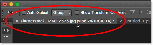 Selecting the main photo's document by clicking its tab. Image © 2015 Photoshop Essentials.com.