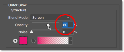 Lowering the opacity of the Outer Glow layer style. 