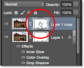 Clicking the layer mask thumbnail in the Layers panel.