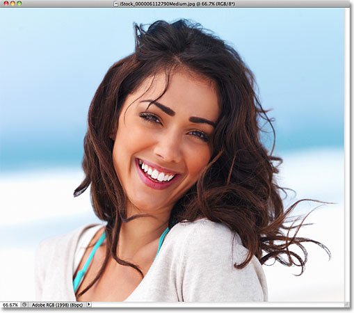 A photo of a woman smiling. Image © 2011 Photoshop Essentials.com.