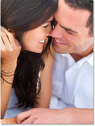 Close up of a smiling young couple in love.