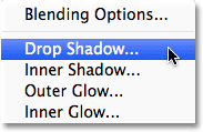 Choosing Drop Shadow from the list of layer styles in Photoshop.