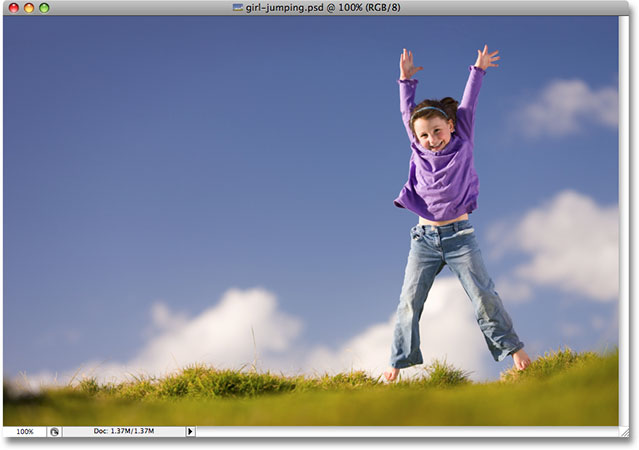 A young girl jumping outdoors. Image licensed from iStockphoto.com by Photoshop Essentials.com.