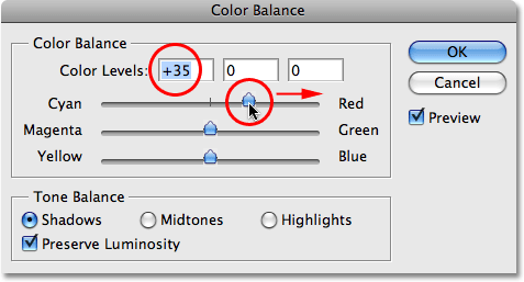 Dragging the top slider towards red in the Color Balance dialog box.