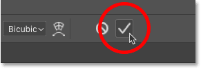 Clicking the checkmark in the Options Bar to close Photoshop's Free Transform command