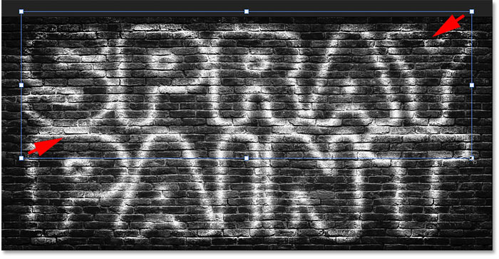 Resizing the copy of the spray painted text effect in Photoshop