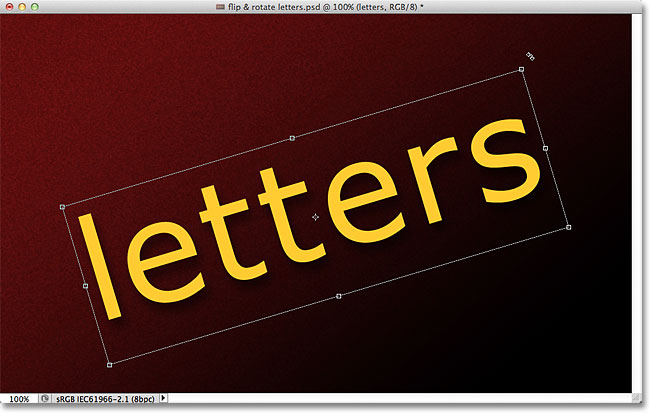Szöveg elforgatása a Free Transform segítségével. Image © 2011 Photoshop Essentials.com.